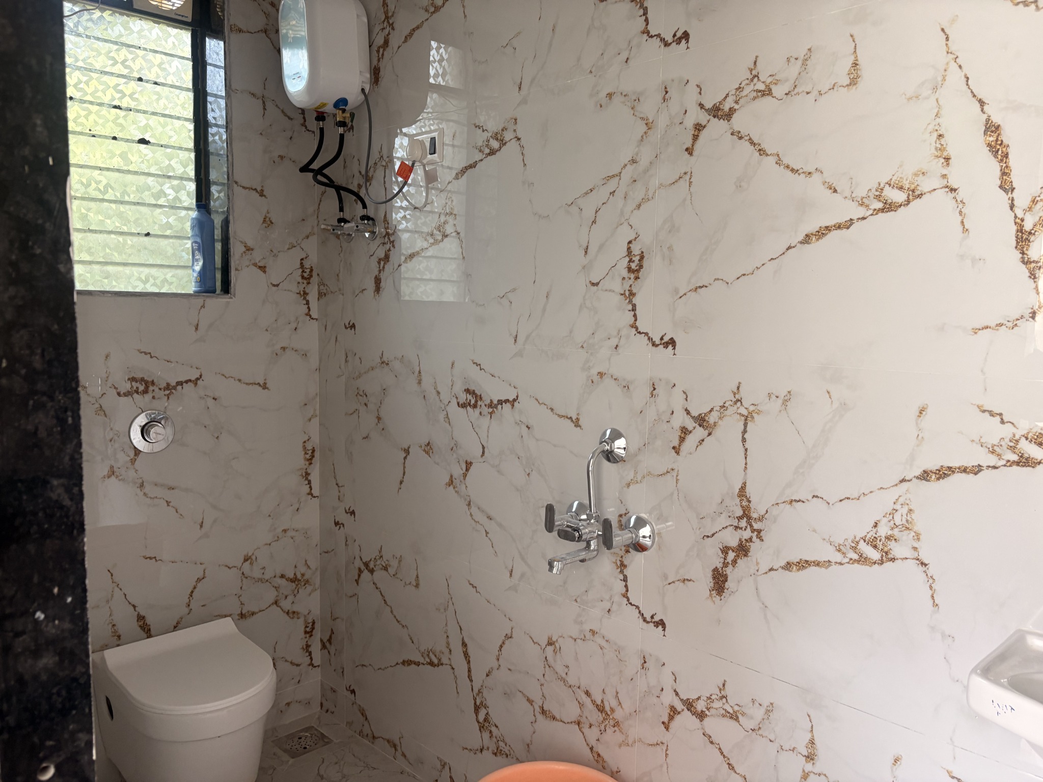 Marble-finish bathroom with modern fittings
