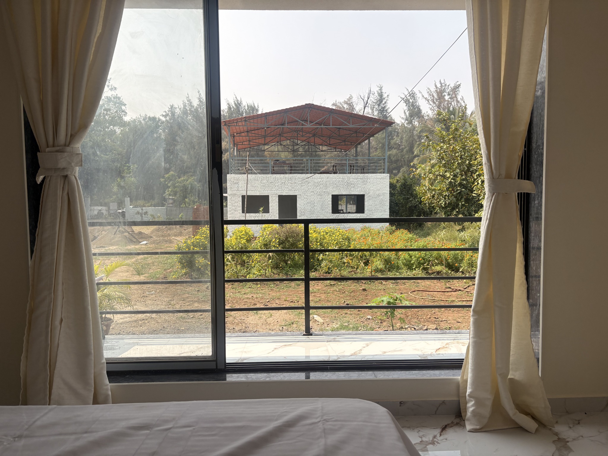 Bright guest bedroom with a large balcony window